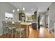 Open kitchen with an island, stainless appliances and hardwood floors at 12433 Bellaire Dr, Thornton, CO 80241