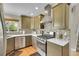 Well-appointed kitchen featuring stainless steel appliances, stylish backsplash, and efficient layout at 12433 Bellaire Dr, Thornton, CO 80241