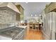 Kitchen with gas range, island seating, stainless refrigerator, and open to the living area at 12433 Bellaire Dr, Thornton, CO 80241