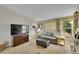 Cozy living room features large TV, lots of light and ample seating for entertaining at 12433 Bellaire Dr, Thornton, CO 80241