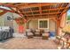 Outdoor patio with comfortable seating, a wooden pergola, and a grill at 12433 Bellaire Dr, Thornton, CO 80241