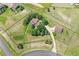 Aerial shot of an estate with fenced yard, circular driveway, detached garage and mature trees on rolling terrain at 25741 E Kettle Cir, Aurora, CO 80016