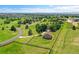 Aerial view of a fenced-in property with home, long driveway and detached garage backing up to a neighborhood at 25741 E Kettle Cir, Aurora, CO 80016