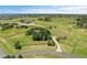 Expansive aerial view of a home surrounded by lush greenery and countryside, with neighborhood in the distance at 25741 E Kettle Cir, Aurora, CO 80016