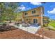Spacious backyard patio with outdoor seating, beautiful landscaping, and mature trees at 25741 E Kettle Cir, Aurora, CO 80016