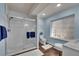 A modern bathroom features a walk-in shower with glass doors and lots of natural light at 25741 E Kettle Cir, Aurora, CO 80016