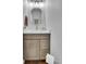 Bathroom features a modern vanity, round mirror, and neutral wall color at 25741 E Kettle Cir, Aurora, CO 80016