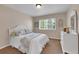 Bedroom with large window, carpet, and dresser at 25741 E Kettle Cir, Aurora, CO 80016