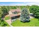 Stunning aerial view of a house featuring a well-kept yard and gorgeous tree in a picturesque suburban setting at 25741 E Kettle Cir, Aurora, CO 80016