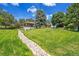 Beautiful two-story home featuring mature trees and a large manicured lawn in a serene landscape at 25741 E Kettle Cir, Aurora, CO 80016