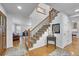 Entryway with hardwood floors, staircase, and views into the living spaces at 25741 E Kettle Cir, Aurora, CO 80016