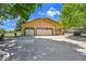 Spacious three-car garage with white doors and ample parking space in a peaceful, rural setting at 25741 E Kettle Cir, Aurora, CO 80016
