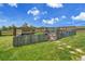 Backyard garden area is fenced and includes raised beds with growing plants at 25741 E Kettle Cir, Aurora, CO 80016