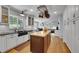 Bright kitchen features hardwood floors, subway tile backsplash, large sink and an island with butcher block top at 25741 E Kettle Cir, Aurora, CO 80016
