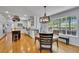 Open floor plan features dining area and kitchen with light cabinets, island and stainless steel appliances at 25741 E Kettle Cir, Aurora, CO 80016