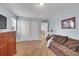 Relaxing living room area with a sofa, dresser, and neutral carpeting at 25741 E Kettle Cir, Aurora, CO 80016