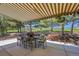 Covered patio with outdoor seating, beautiful landscaping, and mature trees at 25741 E Kettle Cir, Aurora, CO 80016