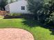 Landscaped backyard with a retaining wall and a charming brick patio at 1230 S Emerson St Dr, Denver, CO 80210