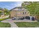 Backyard featuring a brick patio, lounge seating, grill and manicured lawn at 1230 S Emerson St Dr, Denver, CO 80210