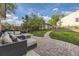 Beautiful backyard patio with comfortable seating, lush lawn, and a brick walkway at 1230 S Emerson St Dr, Denver, CO 80210