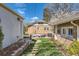 Spacious backyard featuring a well-manicured lawn, a brick patio with outdoor seating, and mature landscaping at 1230 S Emerson St Dr, Denver, CO 80210
