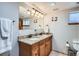 Bathroom features a double sink vanity with granite countertop, modern fixtures, and neutral decor at 1230 S Emerson St Dr, Denver, CO 80210