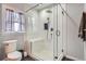Modern bathroom showcasing a glass enclosed shower with bench and rainfall showerhead at 1230 S Emerson St Dr, Denver, CO 80210