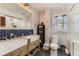 Stylish bathroom featuring double vanity, blue backsplash, and new fixtures at 1230 S Emerson St Dr, Denver, CO 80210