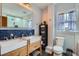 Elegant bathroom featuring a double sink vanity, stylish tile work, and modern fixtures at 1230 S Emerson St Dr, Denver, CO 80210