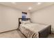 Bedroom with carpet, neutral walls, and a comfortable queen-sized bed and side tables at 1230 S Emerson St Dr, Denver, CO 80210