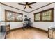 Bedroom features natural light, a ceiling fan, and wood floors at 1230 S Emerson St Dr, Denver, CO 80210