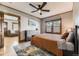Bedroom with ceiling fan, large rug, with glimpse into the living room at 1230 S Emerson St Dr, Denver, CO 80210