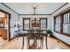 Dining area with modern lighting fixture, wood table, and seamless access to the breakfast bar at 1230 S Emerson St Dr, Denver, CO 80210