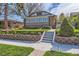 Beautiful brick home with a landscaped front yard, stone retaining wall, and concrete steps to the entrance at 1230 S Emerson St Dr, Denver, CO 80210