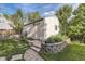 Garage exterior featuring a small brick retaining wall with a landscaped garden at 1230 S Emerson St Dr, Denver, CO 80210