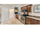Traditional kitchen with stainless appliances, granite counters, and tile flooring at 1230 S Emerson St Dr, Denver, CO 80210