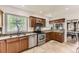 Well-lit kitchen featuring stainless steel appliances, granite countertops, and light brown cabinets at 1230 S Emerson St Dr, Denver, CO 80210