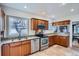 Modern kitchen featuring stainless appliances, granite countertops, and light wood cabinetry at 1230 S Emerson St Dr, Denver, CO 80210