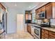 Bright kitchen with stainless appliances, granite countertops and light wood cabinets at 1230 S Emerson St Dr, Denver, CO 80210