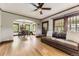 Bright living room with hardwood floors, an open floor plan, and a view into the dining area at 1230 S Emerson St Dr, Denver, CO 80210