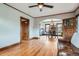 Open concept living and dining area featuring hardwood floors, vintage charm, and a comfortable leather sofa at 1230 S Emerson St Dr, Denver, CO 80210