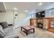 Inviting living room with plush seating, brick fireplace, built-in shelving, and a large flat screen TV at 1230 S Emerson St Dr, Denver, CO 80210