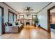 Spacious living room boasts hardwood floors, fireplace, and comfortable leather sofa with bright, natural light at 1230 S Emerson St Dr, Denver, CO 80210
