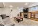 Cozy living room featuring a brick fireplace, built-in shelves, and comfortable seating, perfect for relaxation at 1230 S Emerson St Dr, Denver, CO 80210