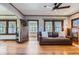 Cozy living room features hardwood floors, ceiling fan, and an inviting open doorway to the sunroom at 1230 S Emerson St Dr, Denver, CO 80210