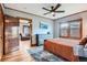 Spacious primary bedroom with hardwood floors, ceiling fan, and ample natural light at 1230 S Emerson St Dr, Denver, CO 80210