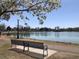 Relax on a park bench overlooking a tranquil lake surrounded by lush greenery and blossoming trees at 1230 S Emerson St Dr, Denver, CO 80210