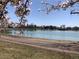 View of the lake in the park with blossoming trees at 1230 S Emerson St Dr, Denver, CO 80210