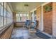 Inviting sunroom with tiled floor, brick accents, ample windows, and comfortable seating for relaxation at 1230 S Emerson St Dr, Denver, CO 80210