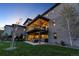 Exterior view of a home featuring a covered deck and manicured lawn at 10095 S Shadow Hill Dr, Lone Tree, CO 80124